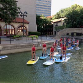 a group of people in a small boat in a body of water