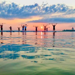 a group of people on a beach near a body of water