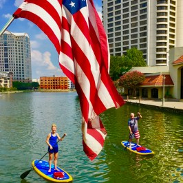 a person flying a kite in a boat on the water