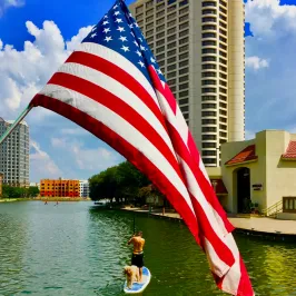 a flag flying in front of a large city